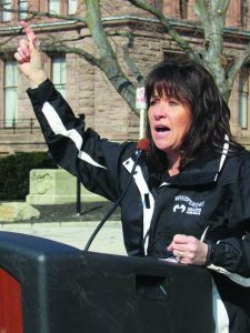 Woman at microphone.