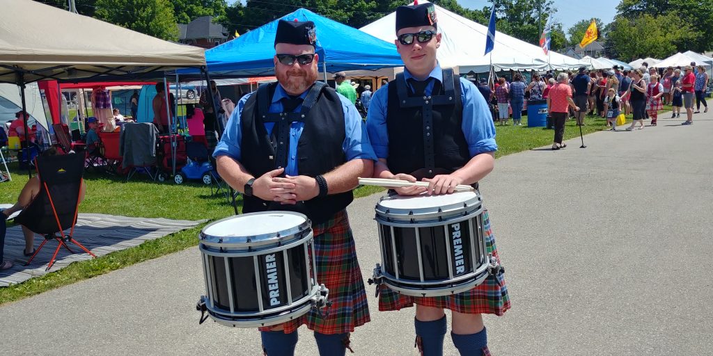 Two men in kilts with drums