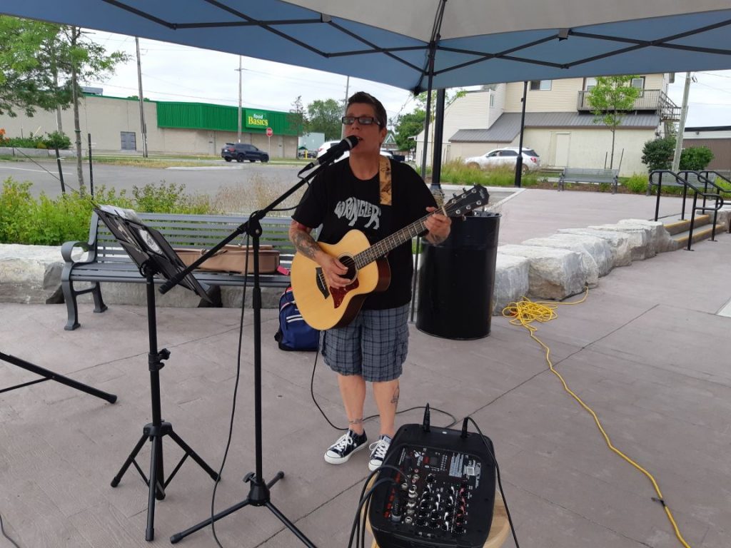 Performer singing and playing guitar