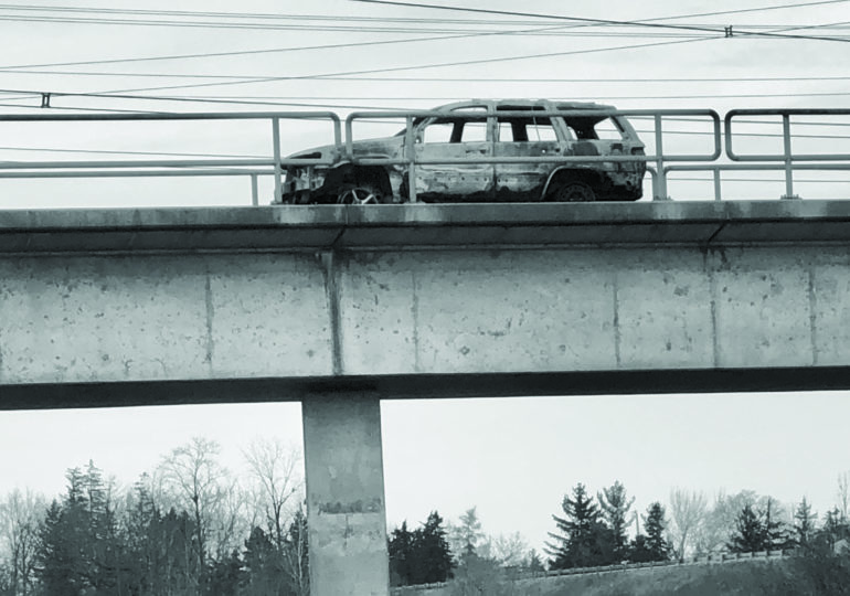 Burned car removed from CN train bridge near  Highway 6 bypass