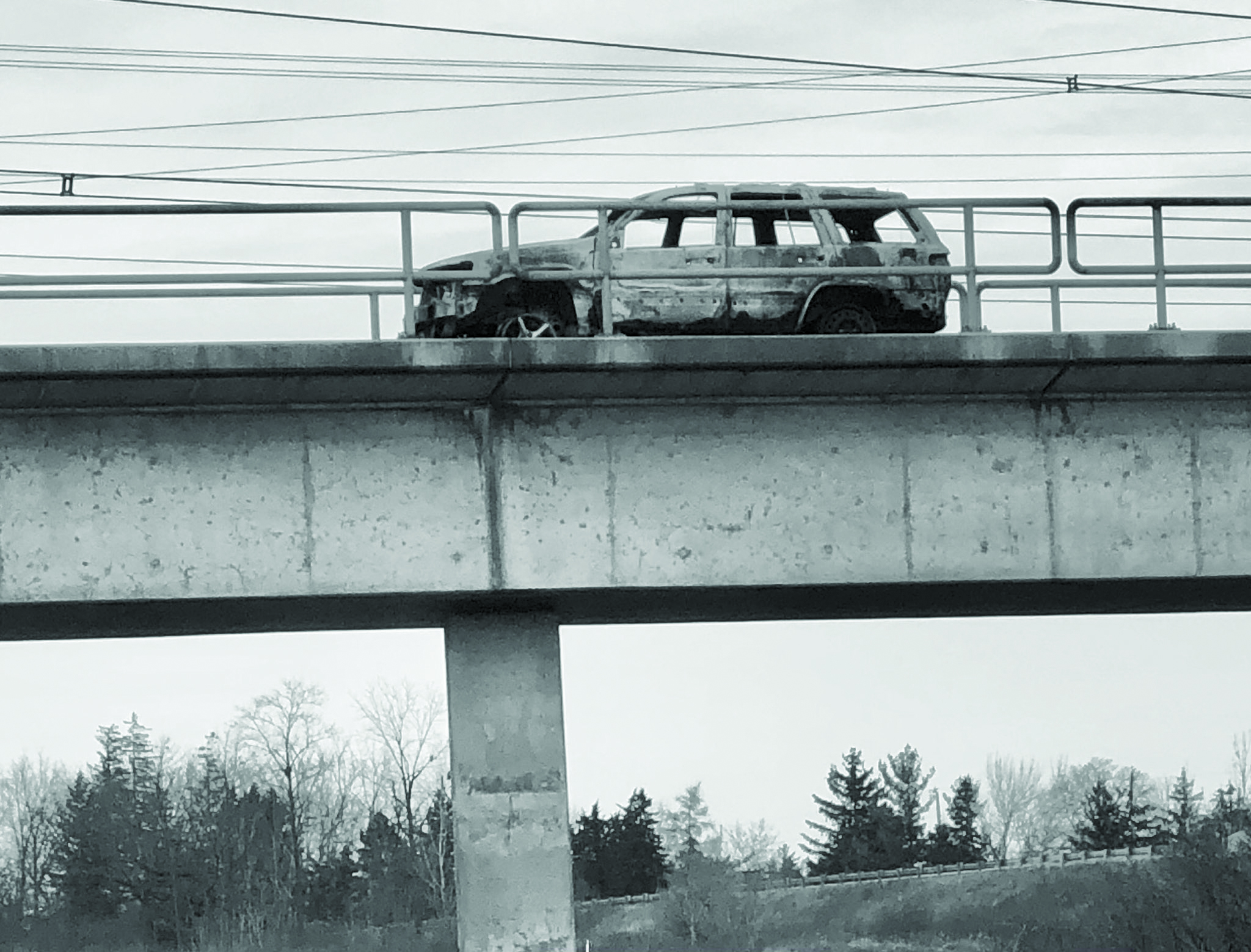 Featured image for Burned car removed from CN train bridge near  Highway 6 bypass